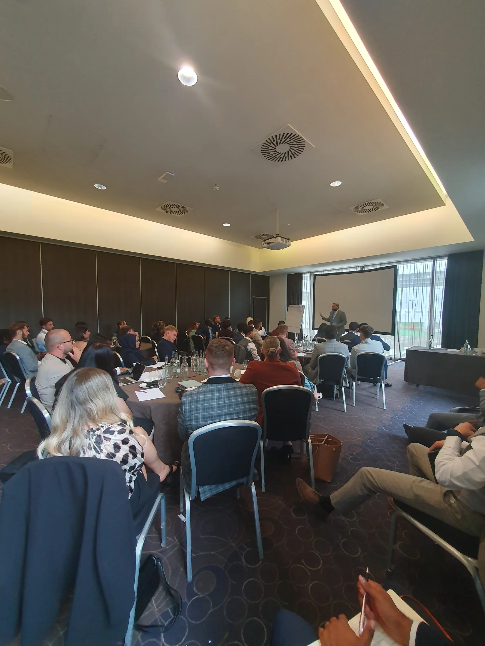 A large audience listening to a speaker