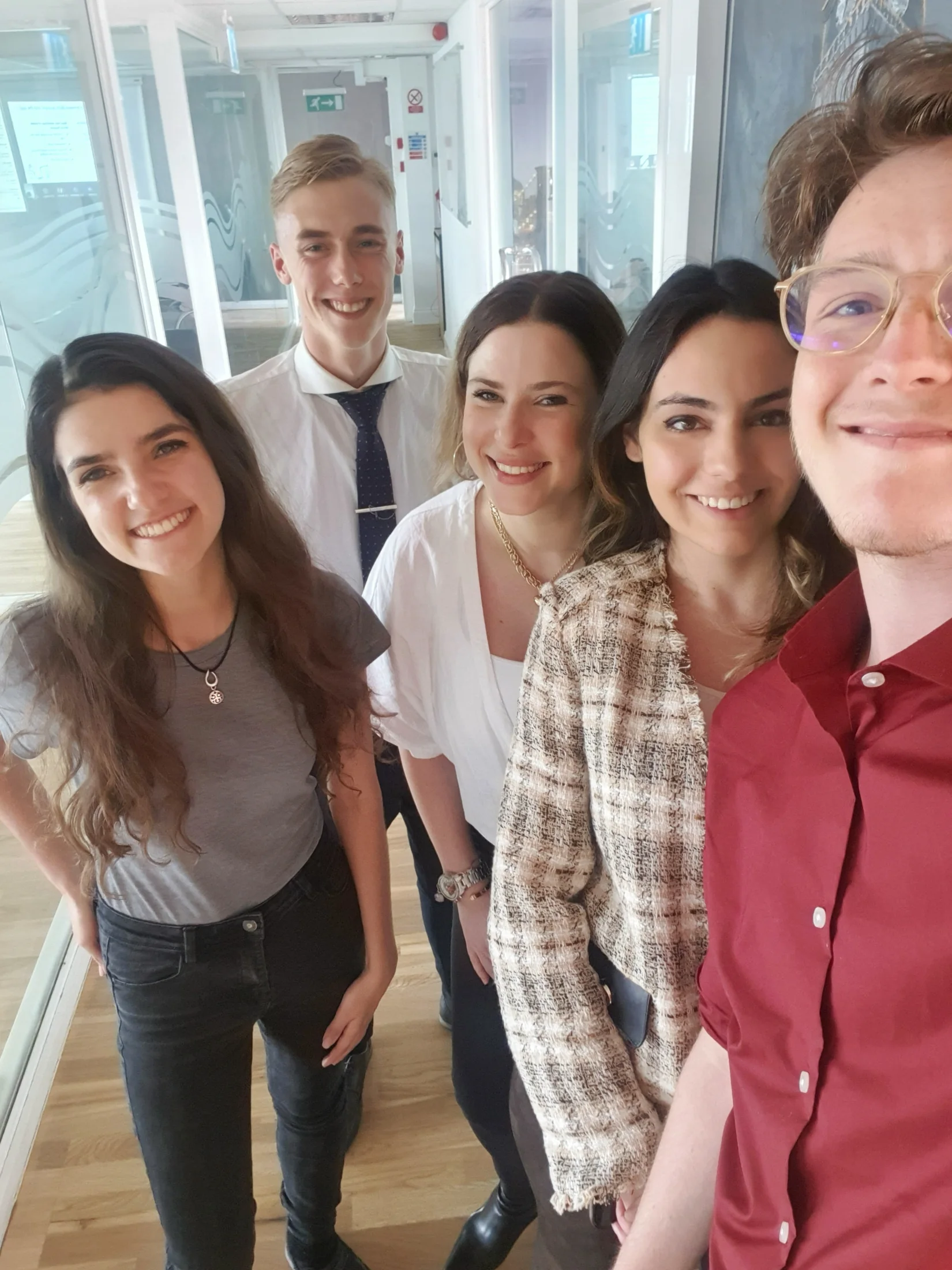 A group standing together in a bright office
