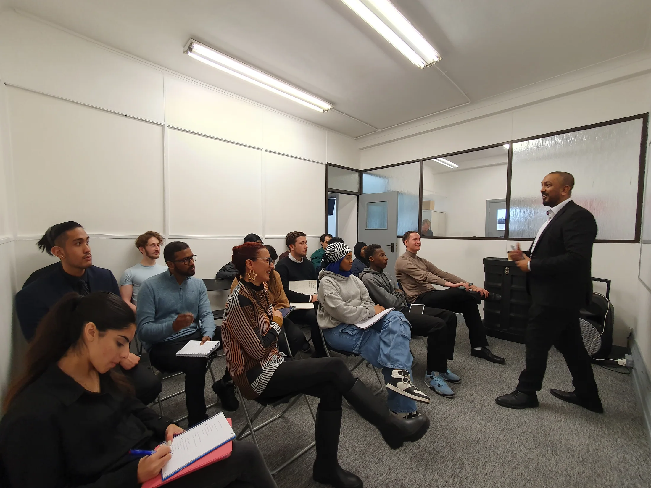 A presenter speaking to a seated team