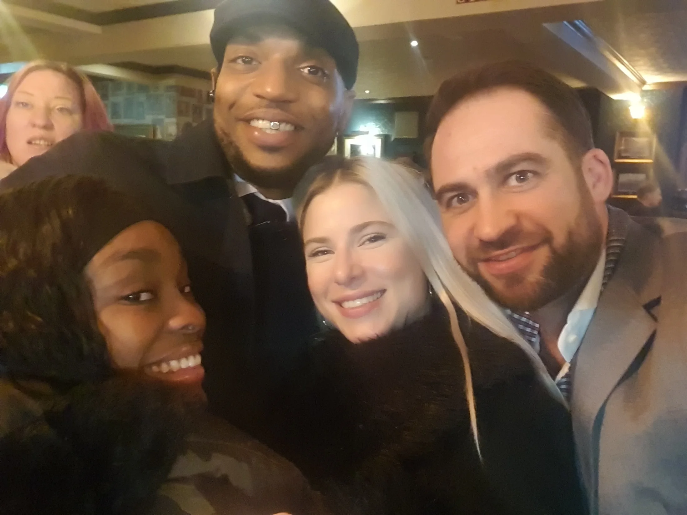A group smiling together at an evening gathering