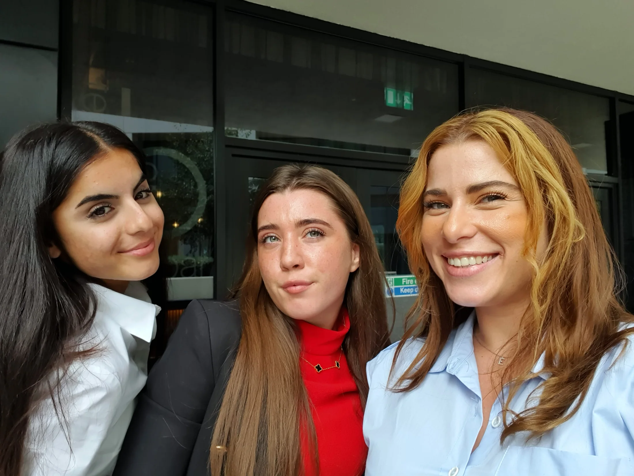 Three team members smiling together